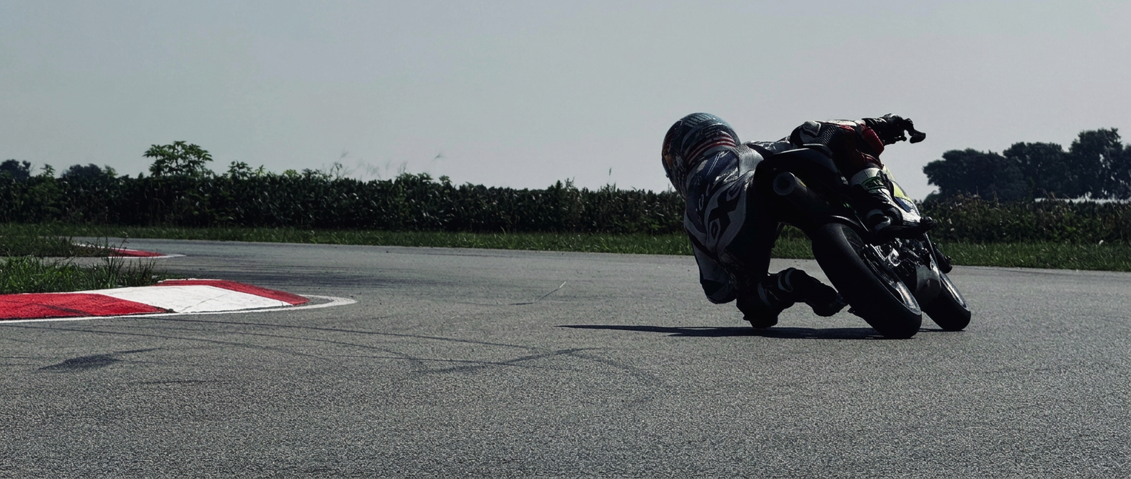 MiniGP rider leaned through a corner on a Midwest race circuit